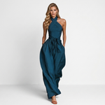 Women's dark teal halter jumpsuit with crossed neckline, gathered waist, wide-leg pants