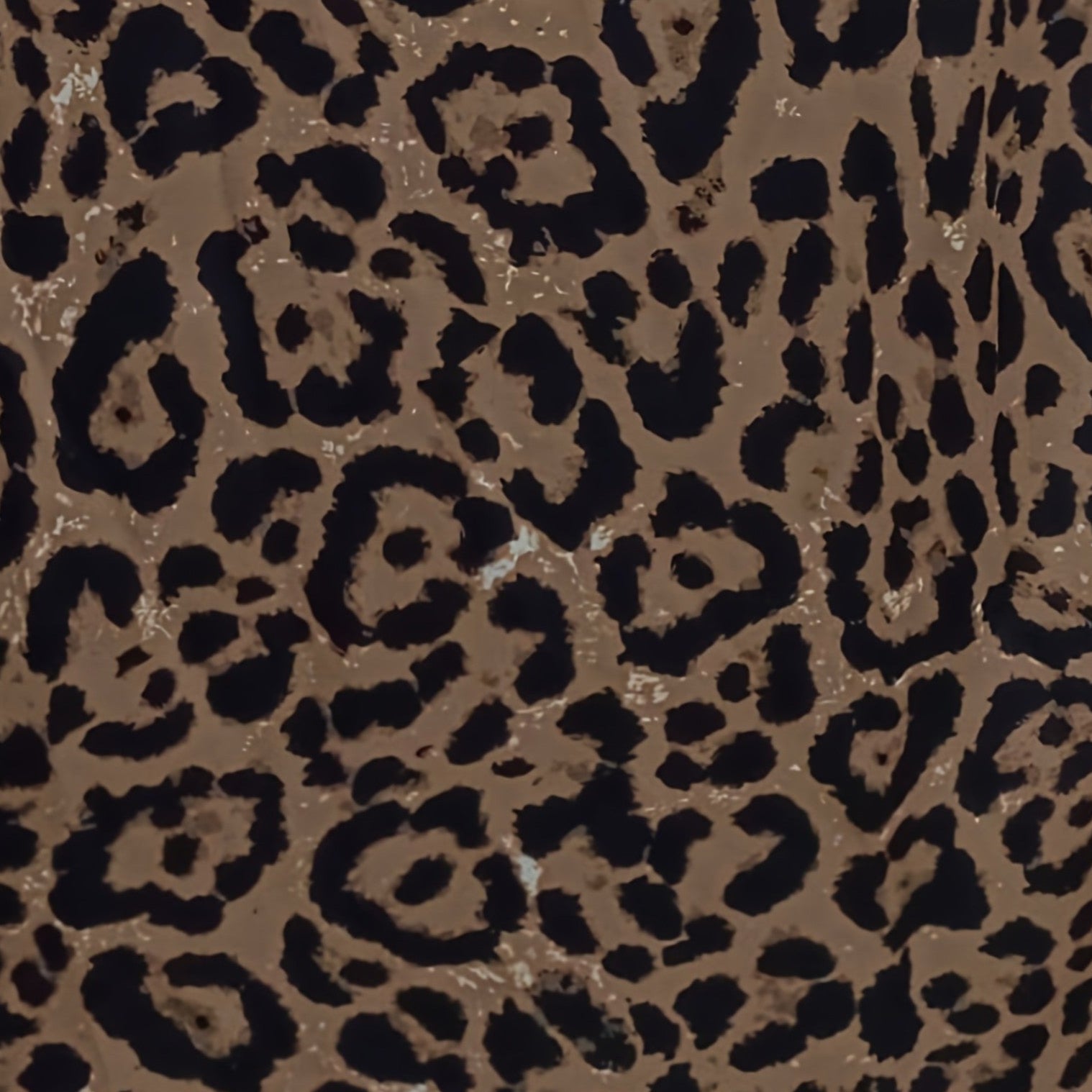 Leopard pattern fabric close-up in tan and dark brown