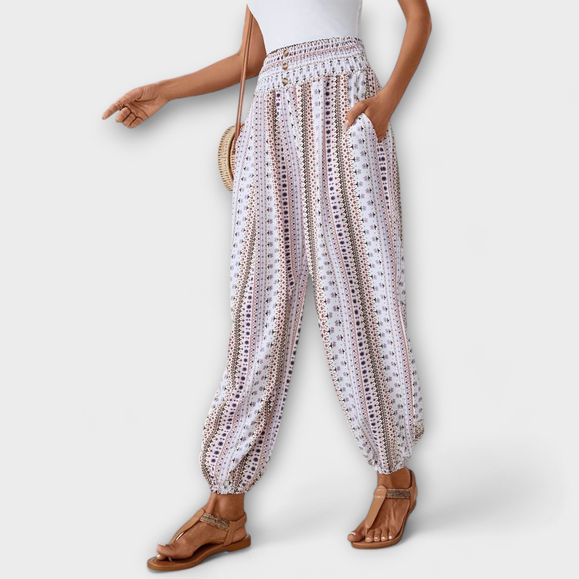 White ethnic harem pants with multicolor vertical print and elastic waistband and ankle cuffs
