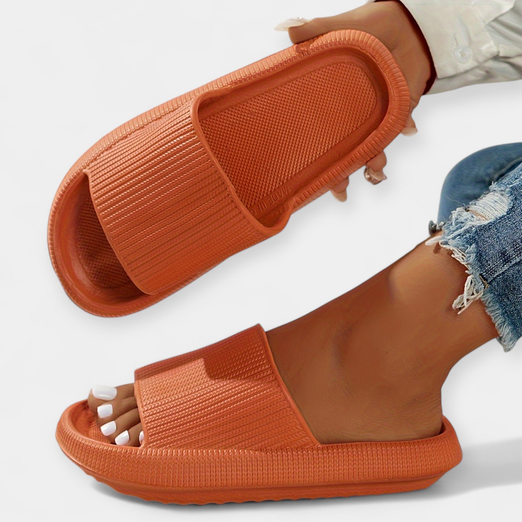 Orange slide sandals with wide textured strap and open toe