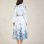 Blue floral midi dress back view, high neck, long sleeves and full gathered skirt