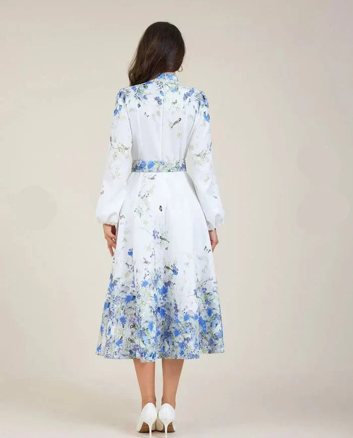 Blue floral midi dress back view, high neck, long sleeves and full gathered skirt