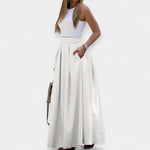 White midi skirt with pleated A-line design and wide waistband