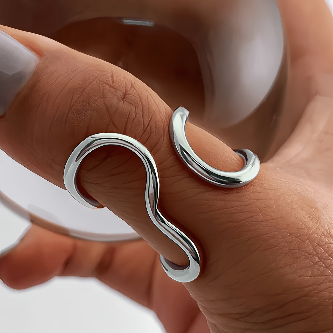 Silver-tone asymmetric wave statement ring with curled open-loop design