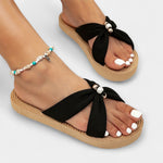 Women's wide bow sandals in black with crossed straps and big bow detail on platform sole