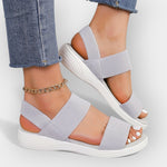 Comfort sandals with wide textured straps, open toe, light gray upper, white platform sole.