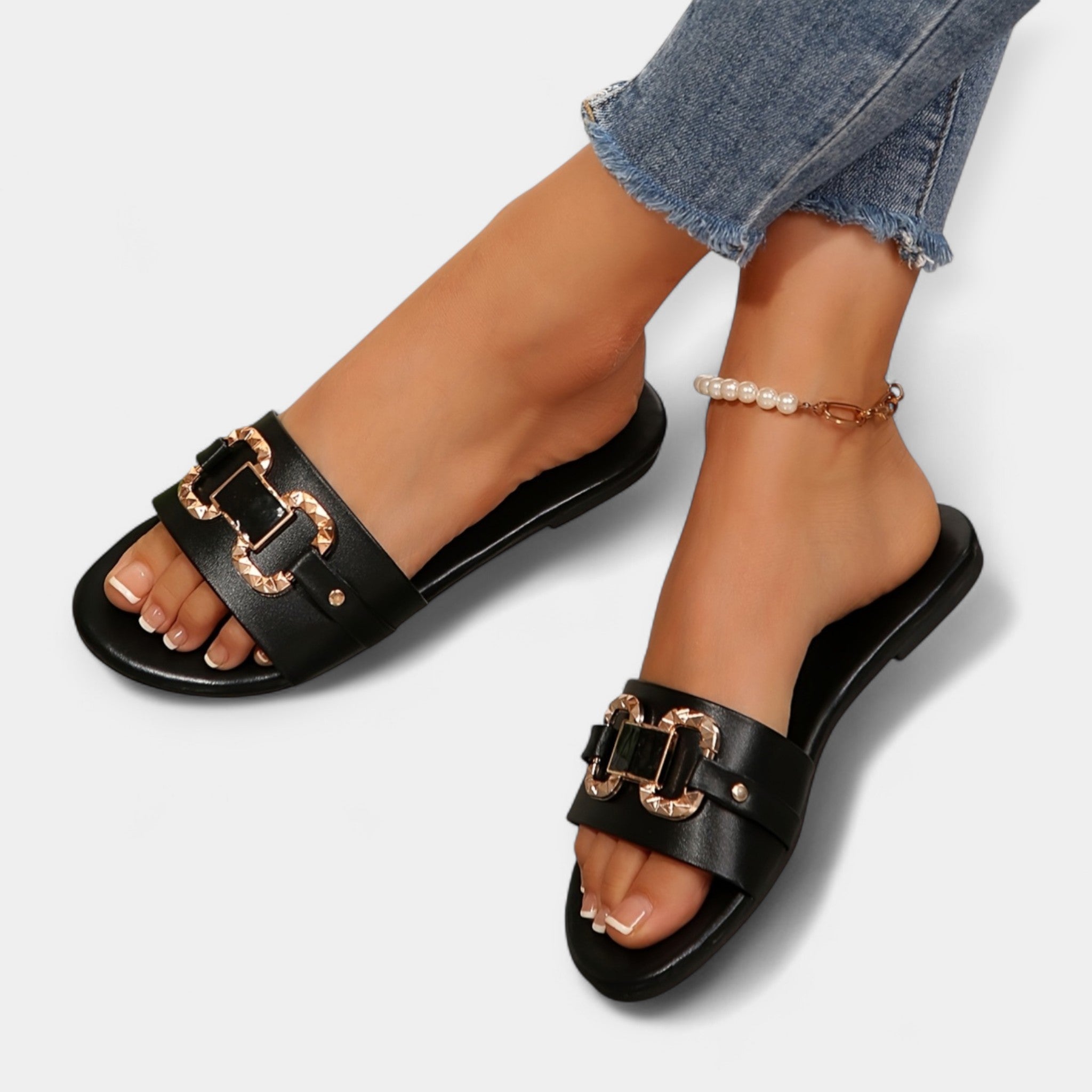 Black comfort sandals with round toe, wide buckled straps and pearl ankle bracelet