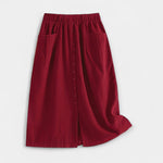 Burgundy midi skirt with elastic waistband, front buttons, and side pockets.