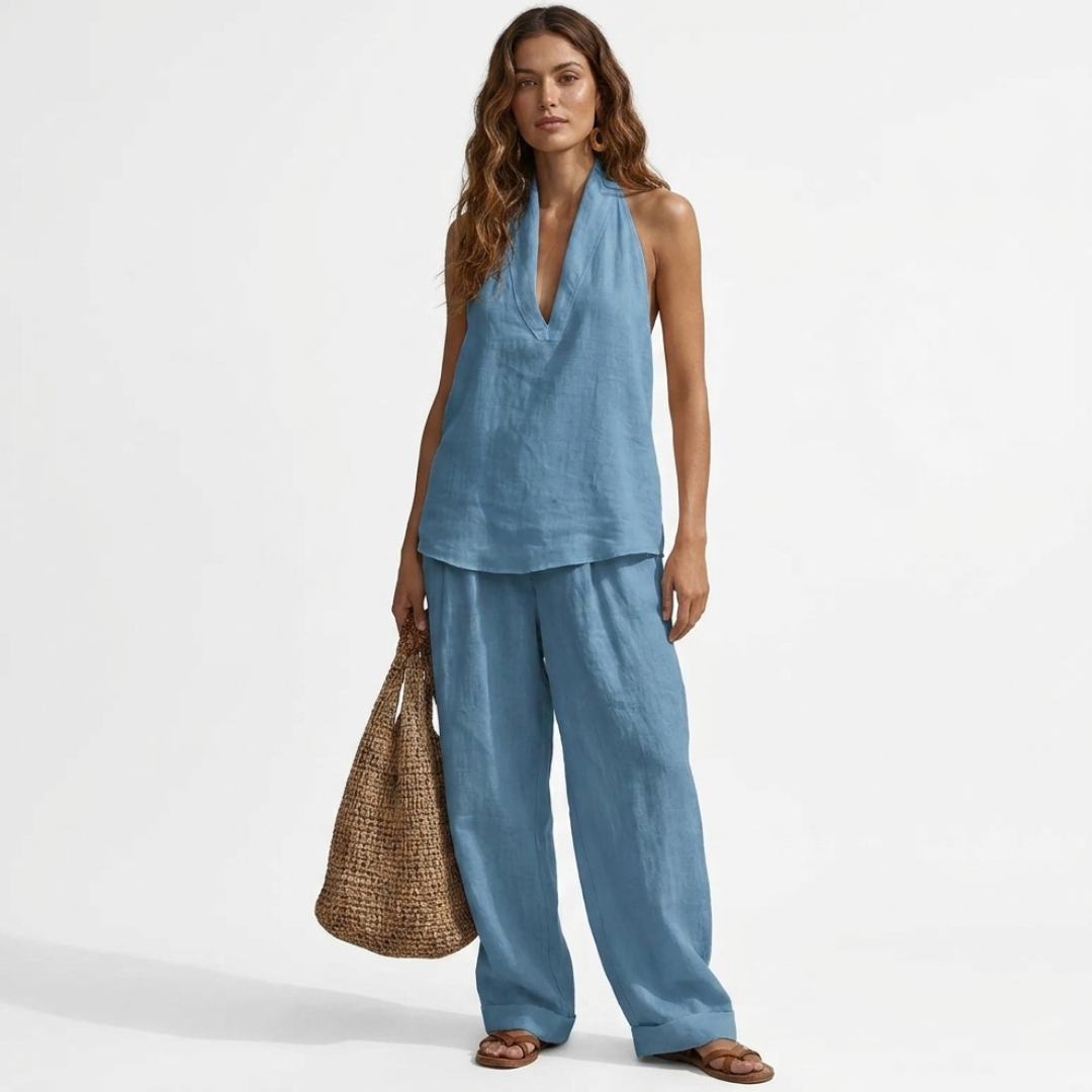 Two-piece V-neck linen set with sleeveless top and wide-leg pants in light blue.