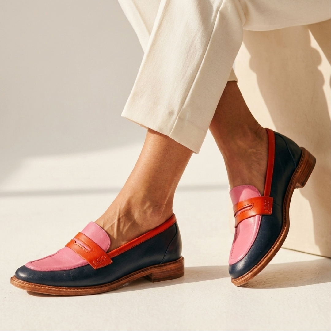 Leather loafers with pink uppers, orange buckle strap, dark navy panels, low heel