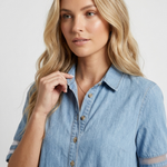 Light blue denim shirt dress close-up: button placket, turn-down collar, short sleeves