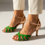 Green high-heel strappy sandals with ankle strap and open toe, crossed ribbon straps