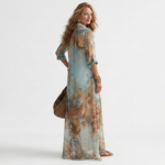 Printed long shirt dress with V-neck and three-quarter sleeves, side view, aqua and tan.