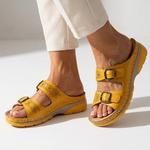 Yellow orthopedic sandals with two adjustable buckles, perforated straps, and cushioned sole