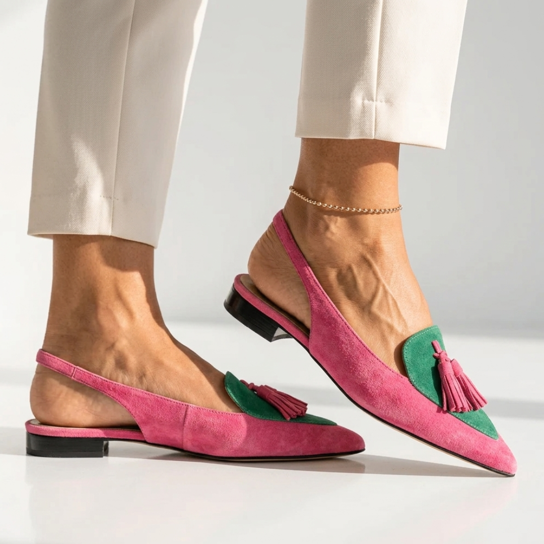 Pink suede pointed-toe flats with green inserts and tassel accents, low block heel.