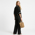 Black graphic trim set with V-neck shirt and wide-leg pants, back view