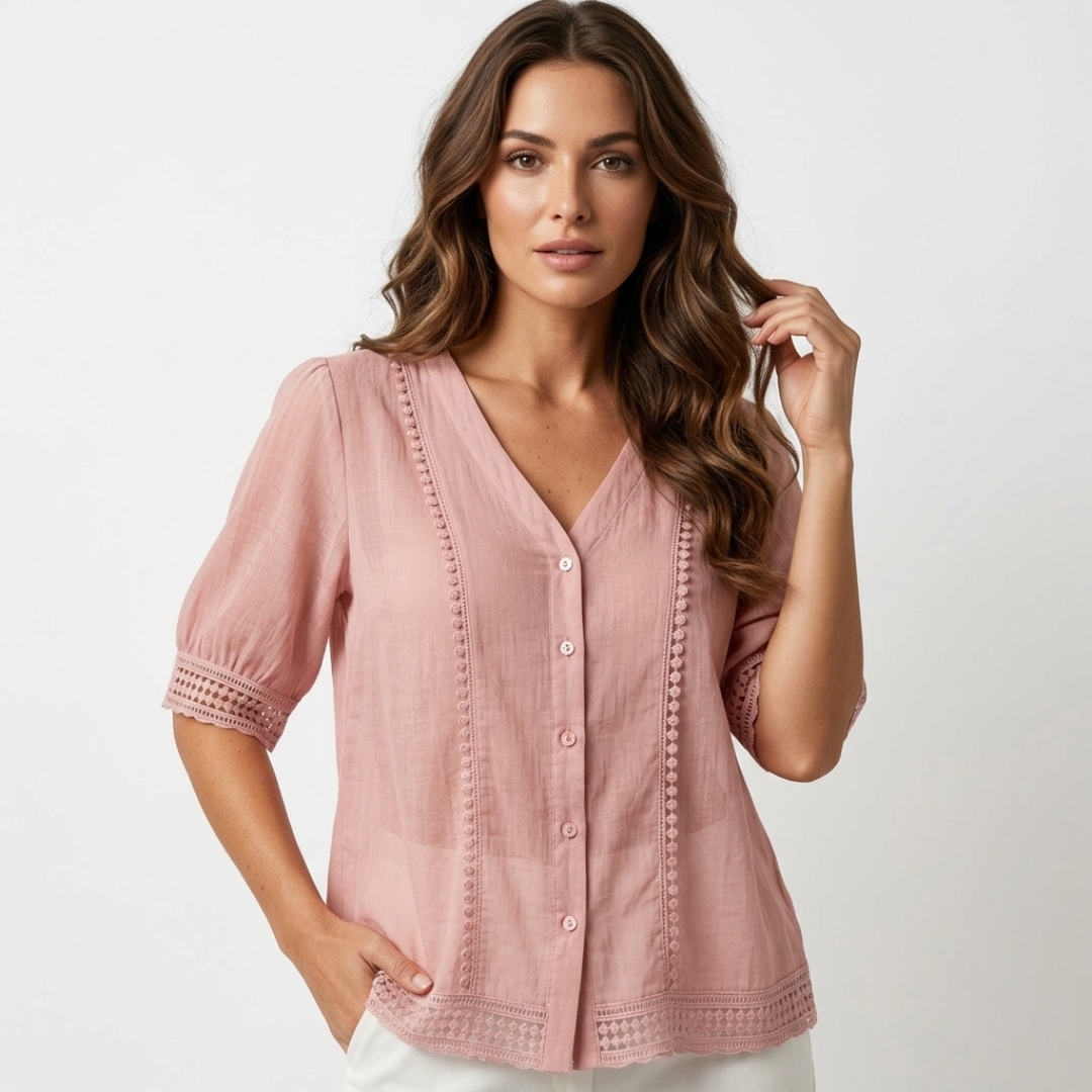 Light pink lightweight blouse, V-neck button front, short sleeves with eyelet trim.
