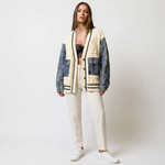 Patchwork cardigan with cream knit body, dark denim sleeves, patch pockets, button front