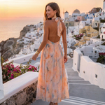 Orange watercolor silk halter midi dress with open back and flowing skirt