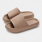 Light beige textured slip-on slide sandals with quilted footbed and thick sole