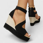 Black open-toe wedge sandals with ankle strap and textured wedge heel