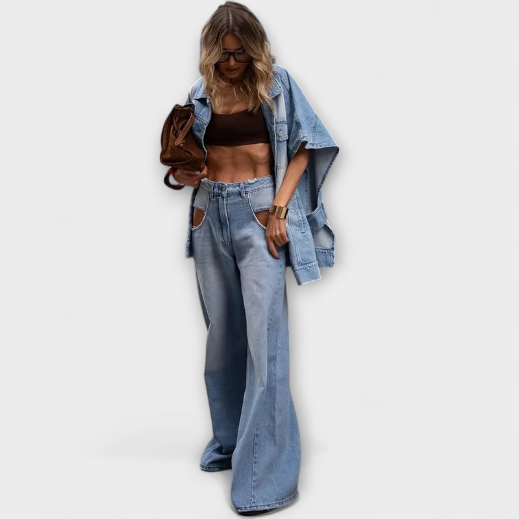 Light-wash denim wide-leg jeans with a front pocket and belt loops, worn with denim jacket