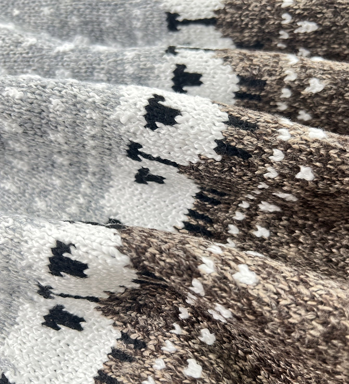 Grey knit fabric close-up with Fair Isle pattern