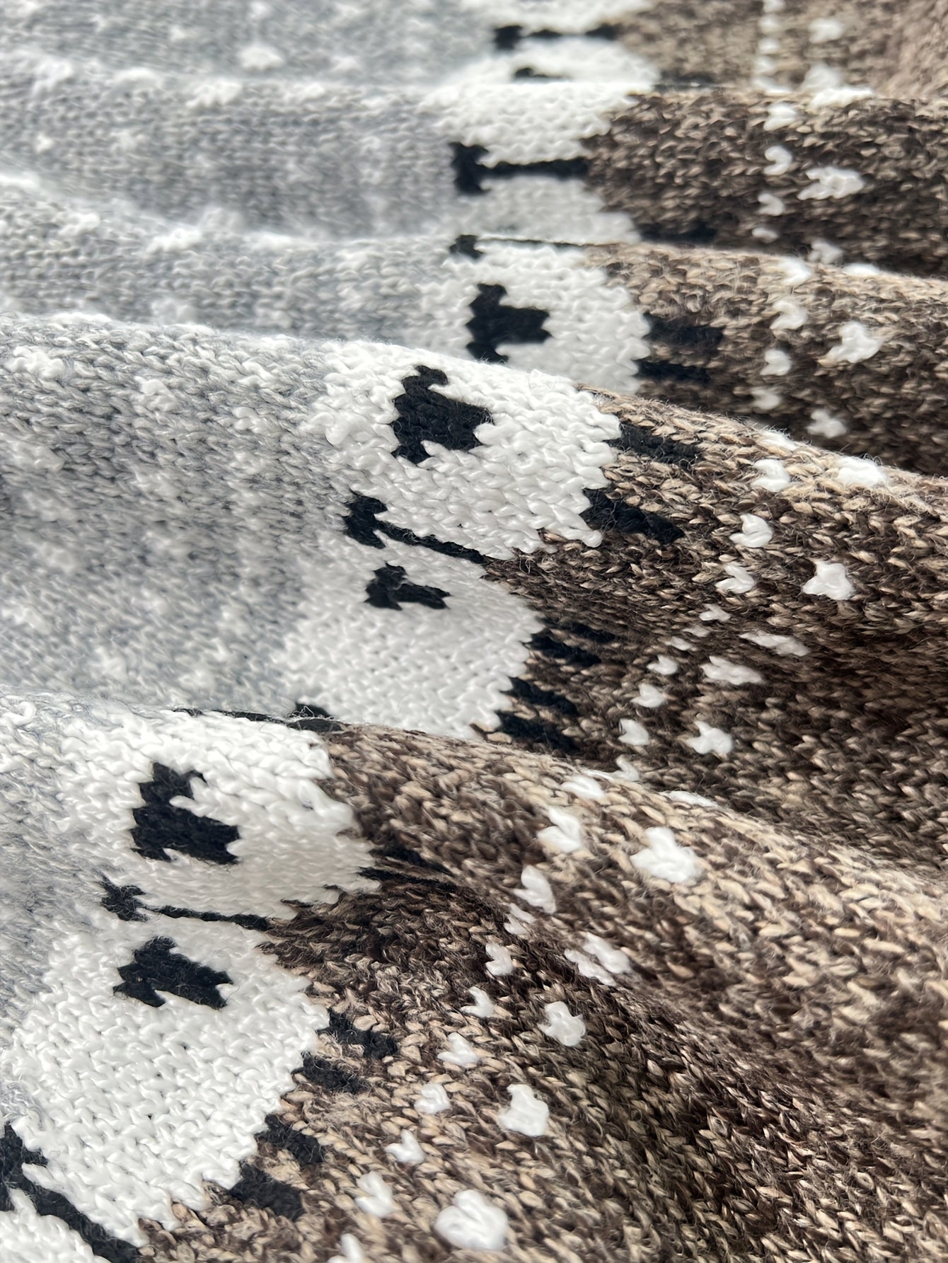 Grey knit fabric close-up with Fair Isle pattern