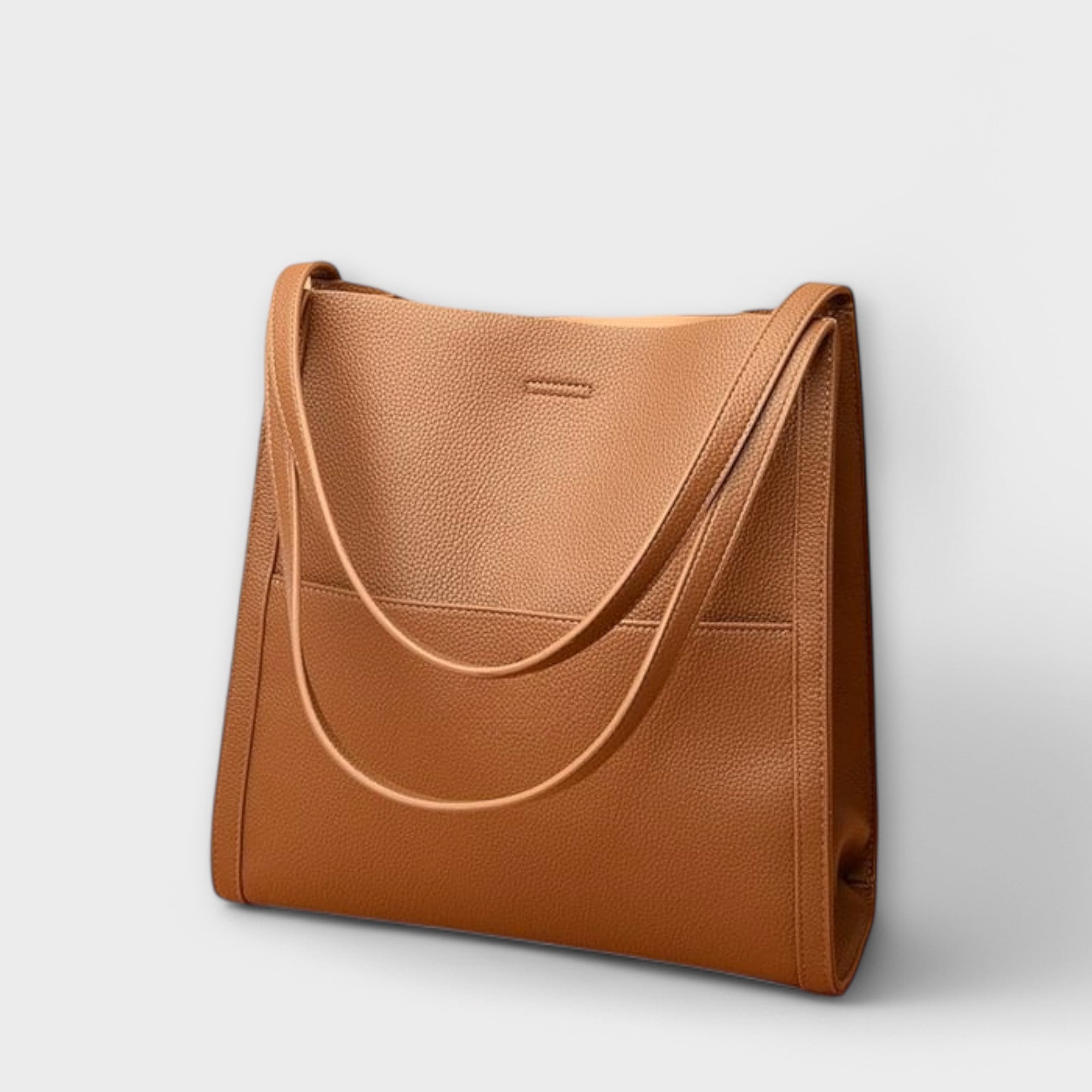 Caramel natural leather tote bag with curved strap handles and front tab detail