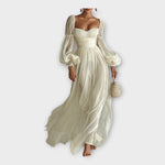 Light cream romantic maxi dress, smocked bodice and waist, voluminous puff sleeves, long skirt