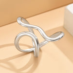 Silver asymmetric wave statement ring with open band and curved links