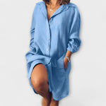 Loose linen shirt-dress, light blue, button-front, point collar, long sleeves, relaxed fit.