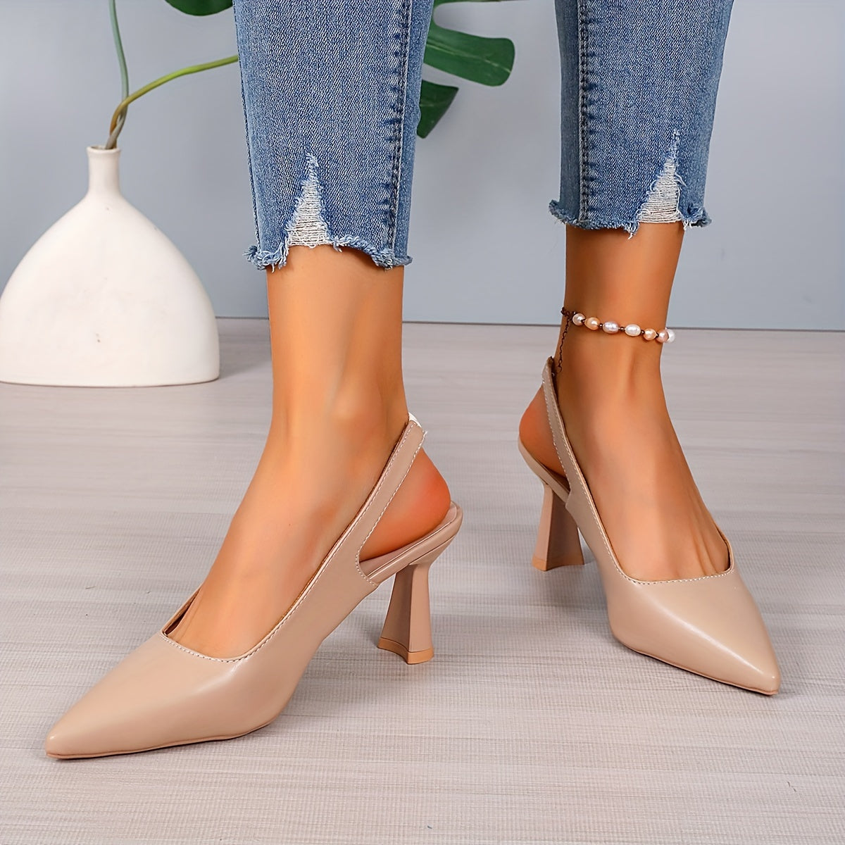 Beige orthopedic pointed-toe heels with slingback strap and mid block heel