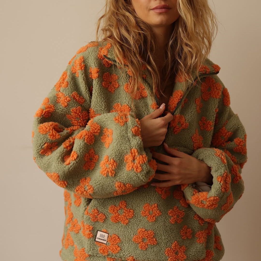 Olive fuzzy fleece half-zip hoodie with orange flower pattern and hooded neckline