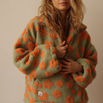 Olive fuzzy fleece half-zip hoodie with orange flower pattern and hooded neckline