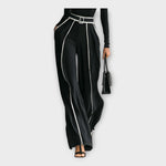 Women's black wide-leg jumpsuit with contrast piping and belt, side view