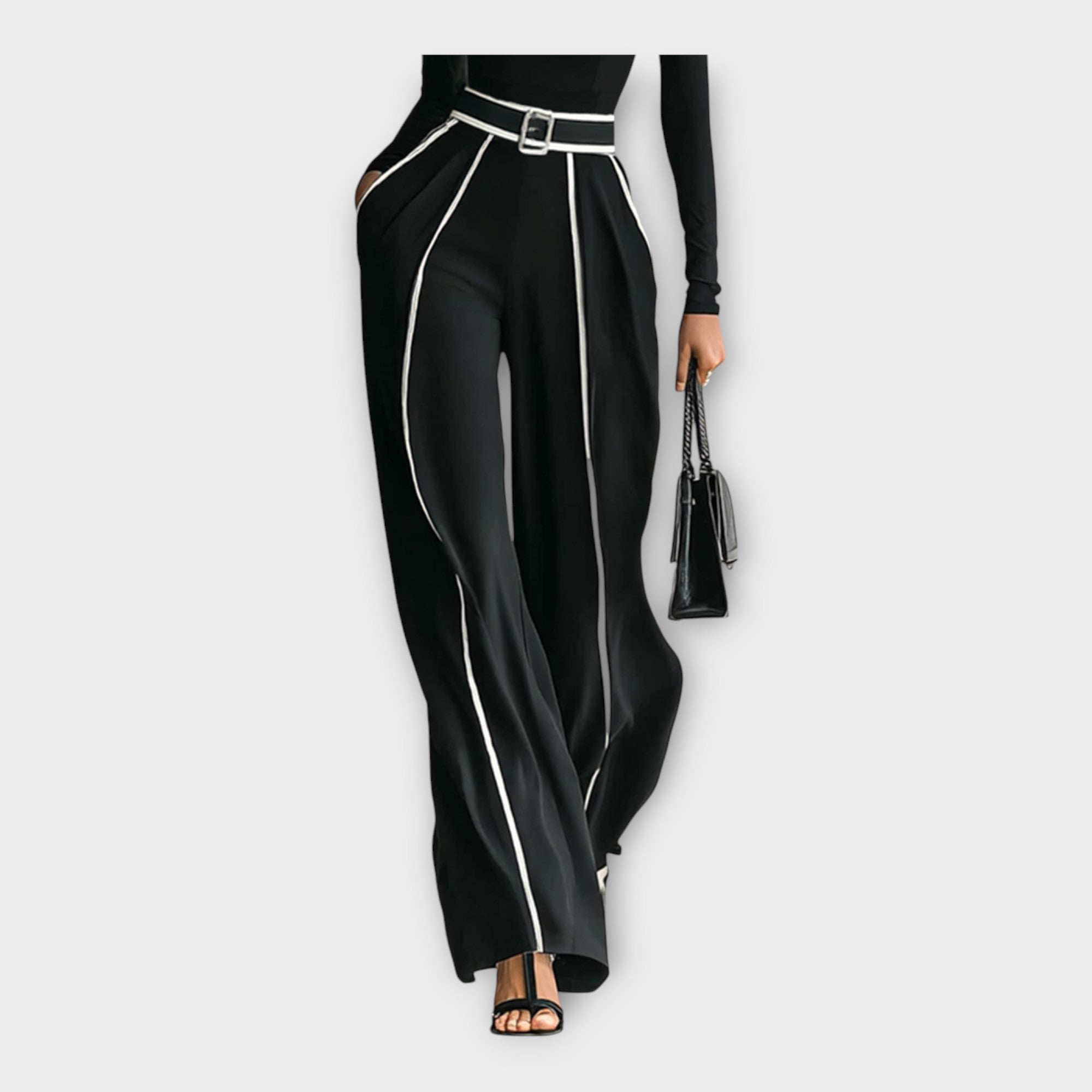 Women's black wide-leg jumpsuit with contrast piping and belt, side view