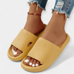 Home and beach slippers in mustard-yellow with ribbed slide strap, open toe