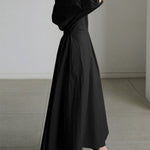Black long button-front dress with puff sleeves and waist tie, gathered full hem