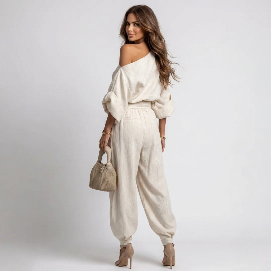 Off-white one-shoulder top with wide sleeves and matching relaxed harem pants