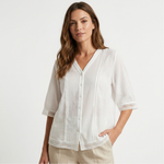 White lightweight blouse, V-neck button front, eyelet-trim cuffs and vertical crochet panels.