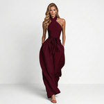 Women's maroon halter jumpsuit with crossed neckline, gathered waist, wide-leg pants