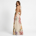 Anca backless halter floral maxi dress with bow tie, pale base with garden print