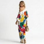 One-shoulder maxi dress side view, white with bold multicolor abstract print and 3/4 sleeves