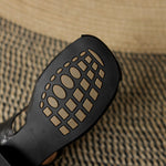 Black natural leather sandal outsole with molded tread pattern