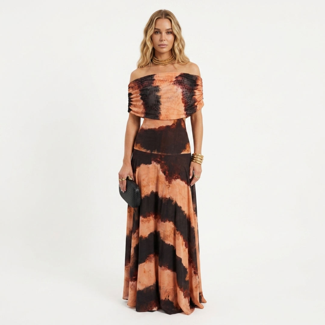 Off-shoulder long maxi dress with rust and black tie-dye print, flowing skirt