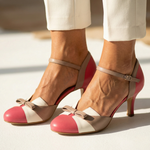 Pink, white, and green leather heeled pumps with ankle strap and bow