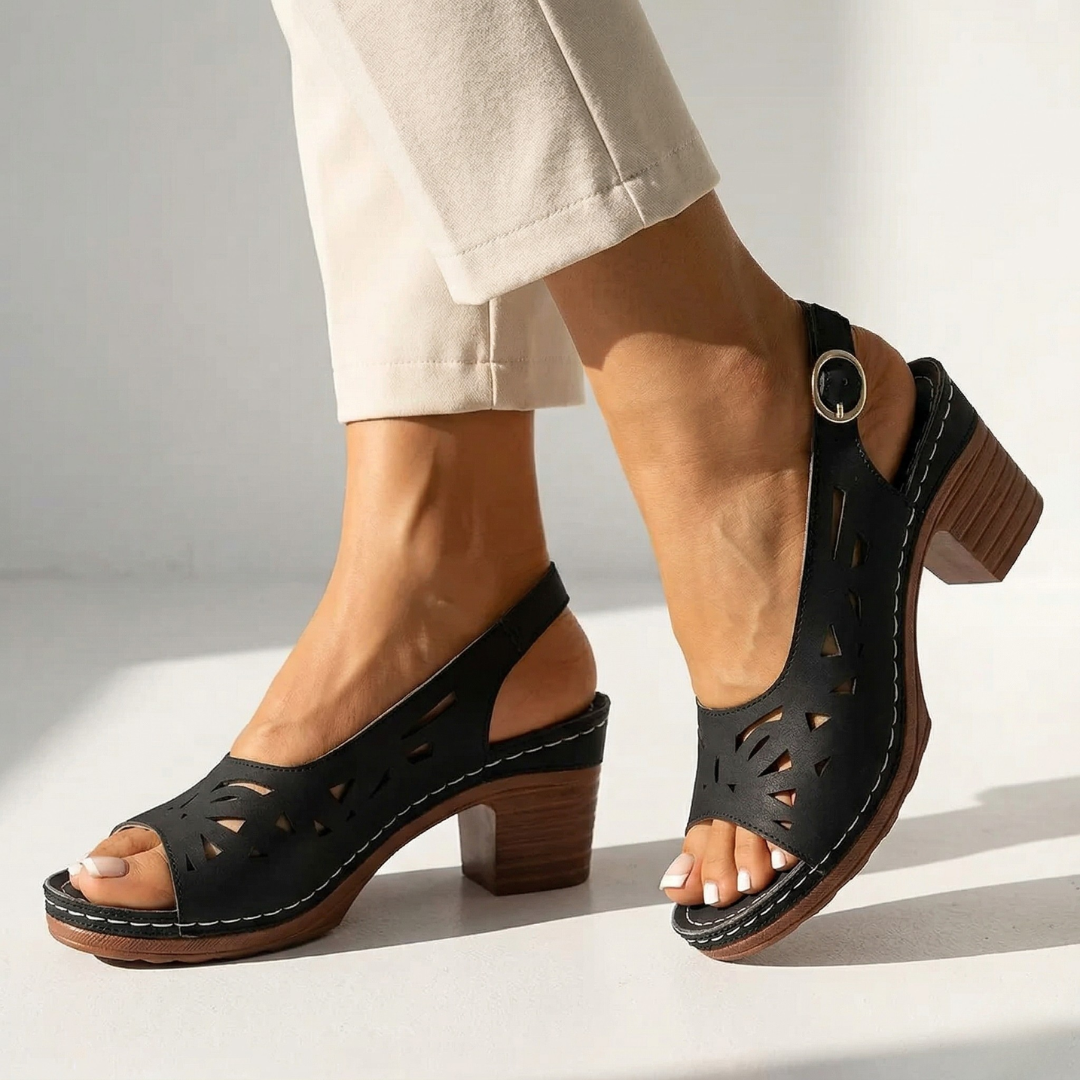 Black orthopedic slide sandals with cutout uppers and chunky wooden block heel