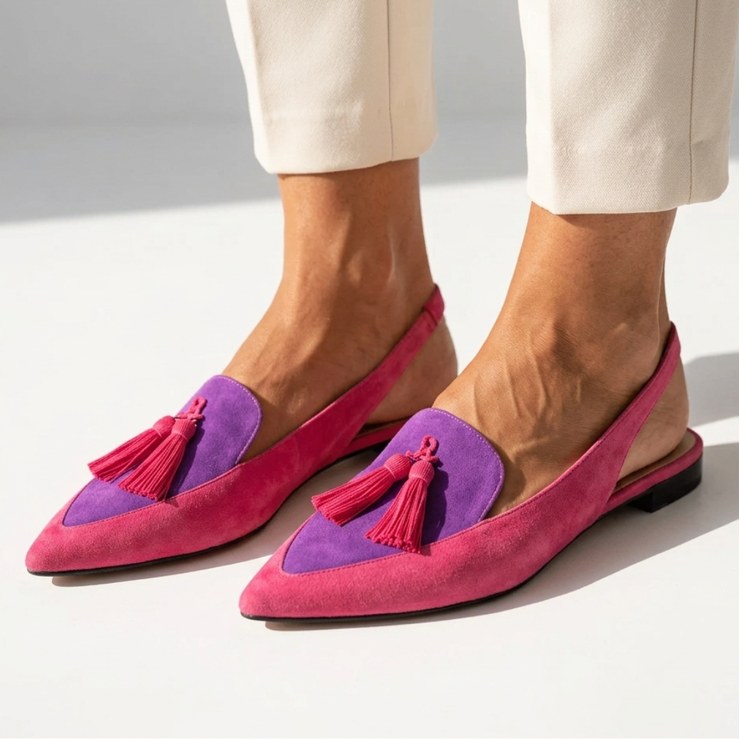 Purple and pink pointed-toe flats with pink tassel details and flat heel.