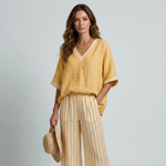 Women's yellow V-neck top and striped wide-leg pants with contrast-trim sleeves